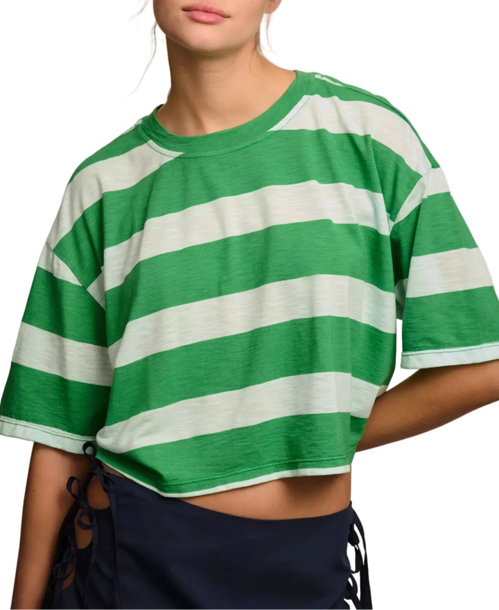 Person wearing a green and white striped shirt against a plain background