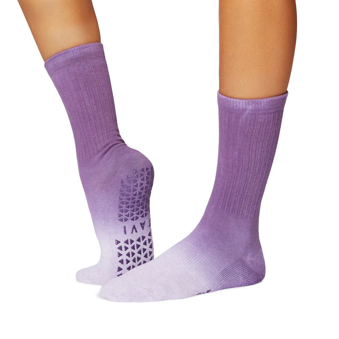 Purple socks with textured sole on a white background