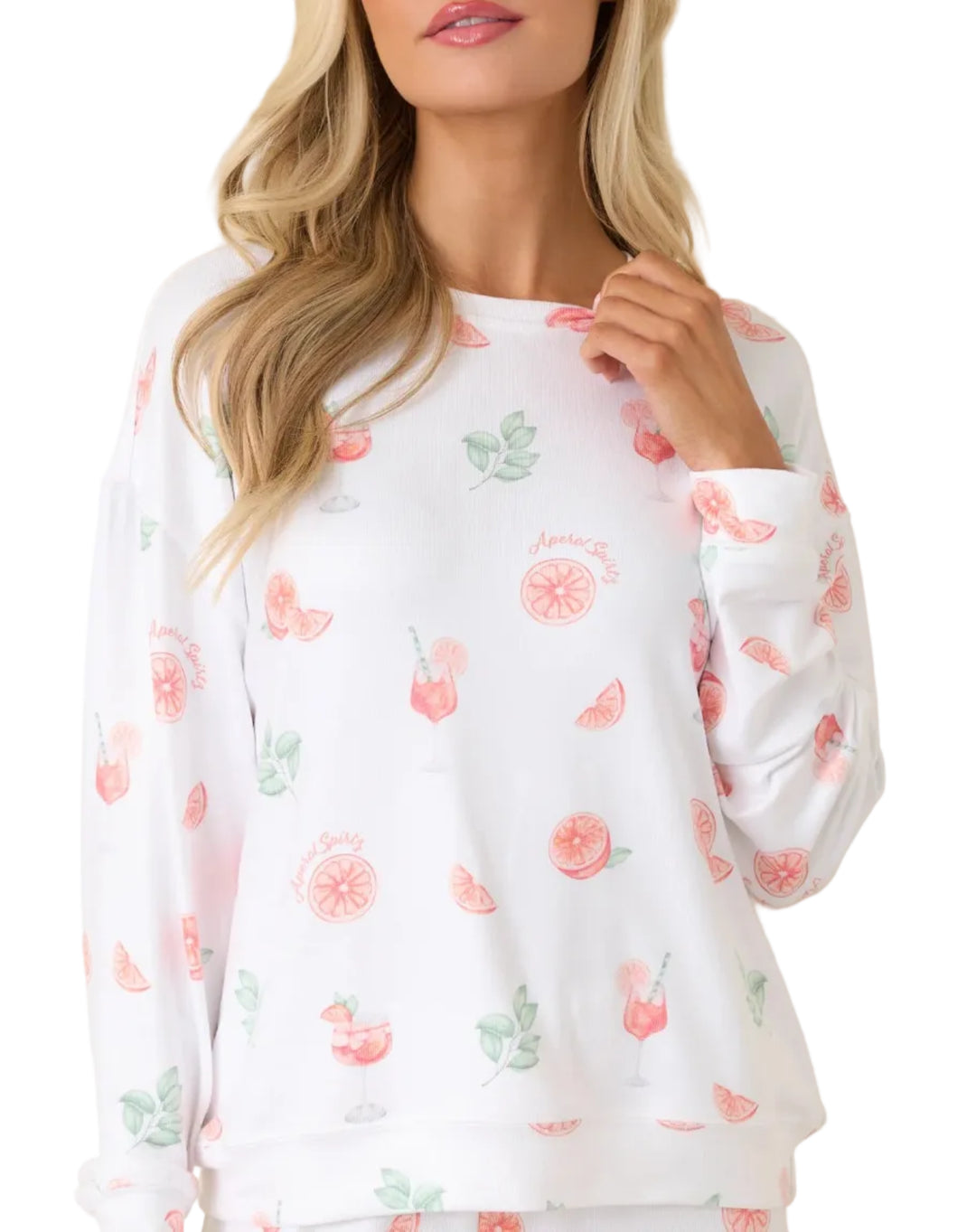 Woman wearing a white long-sleeve shirt with floral pattern on a beige background