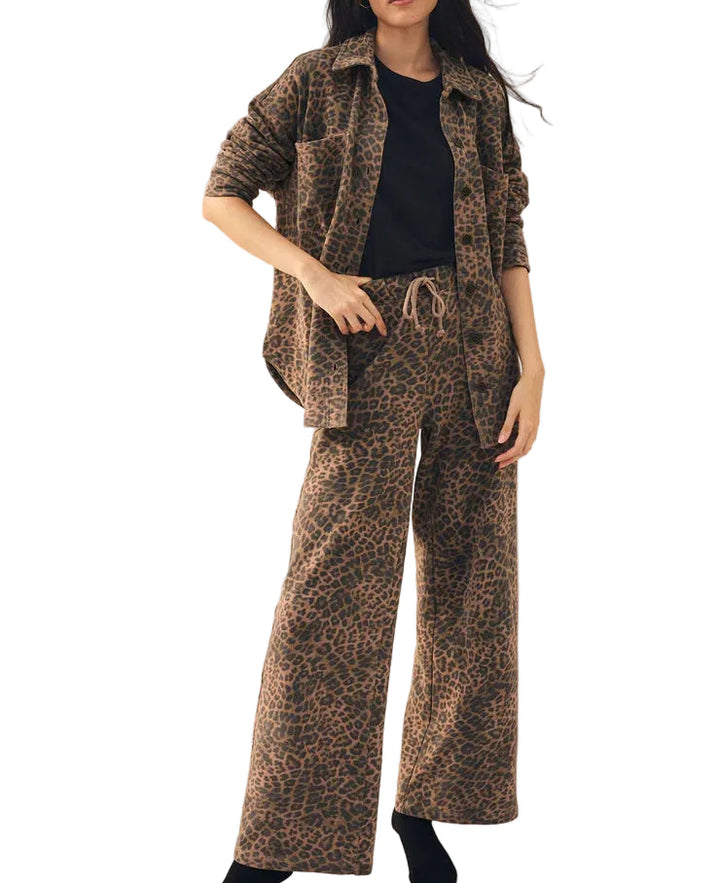 Person wearing a leopard print outfit on a white background