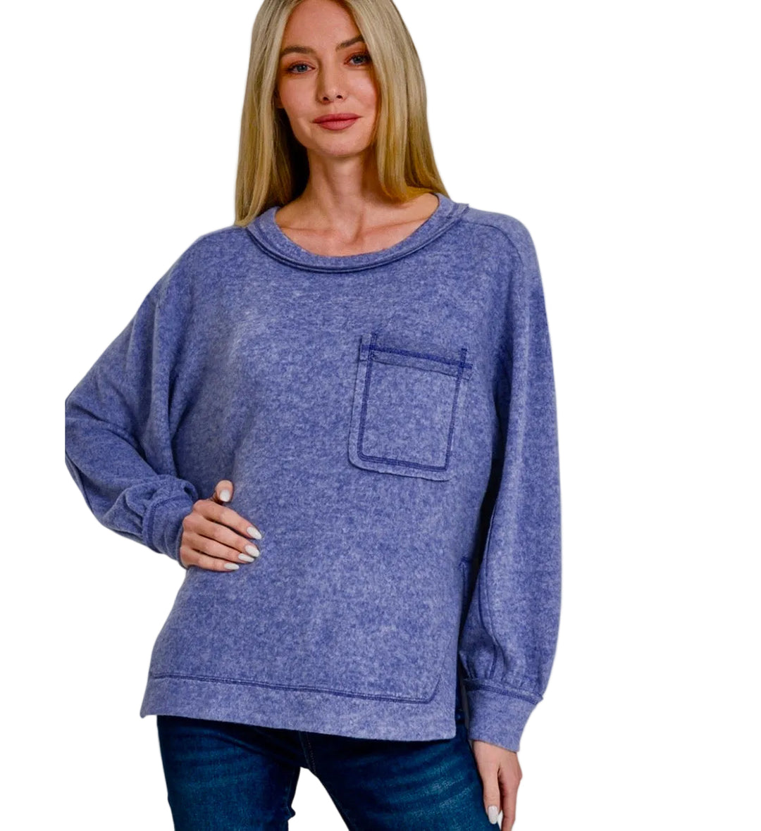 A woman modeling a heathered periwinkle blue crewneck sweatshirt with a chest pocket, paired with dark blue jeans against a light gray background. Text overlays read 'BRUSHED MIDWEATER SOFT' and 'MARLIN'.