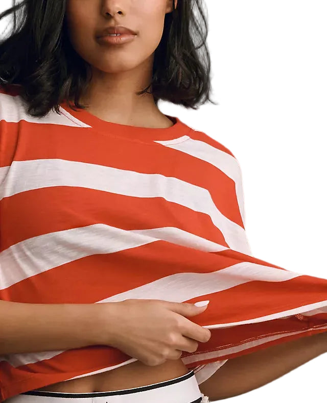 Person wearing a red and white striped shirt with a white background