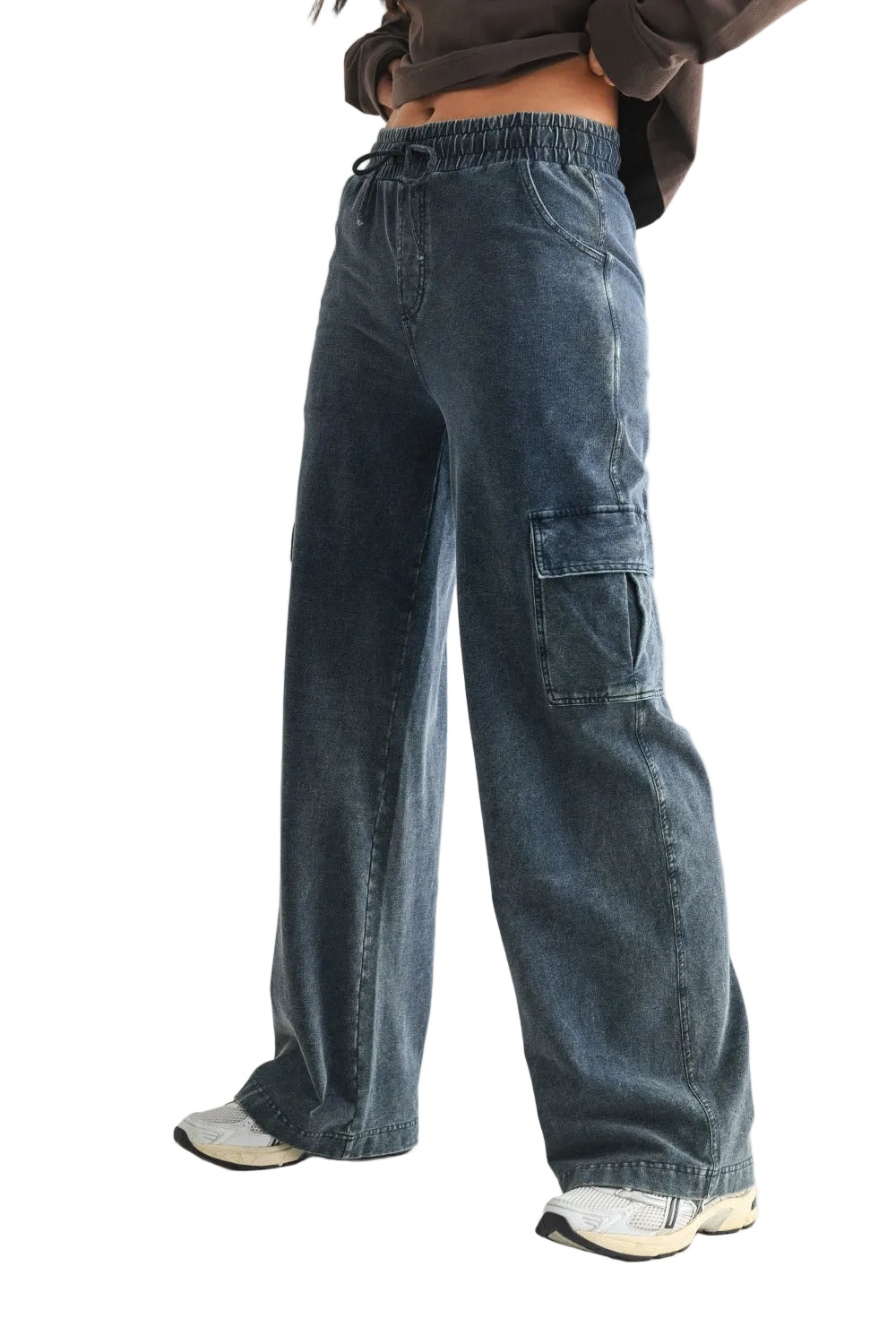Blue cargo pants worn by a person on a light gray background