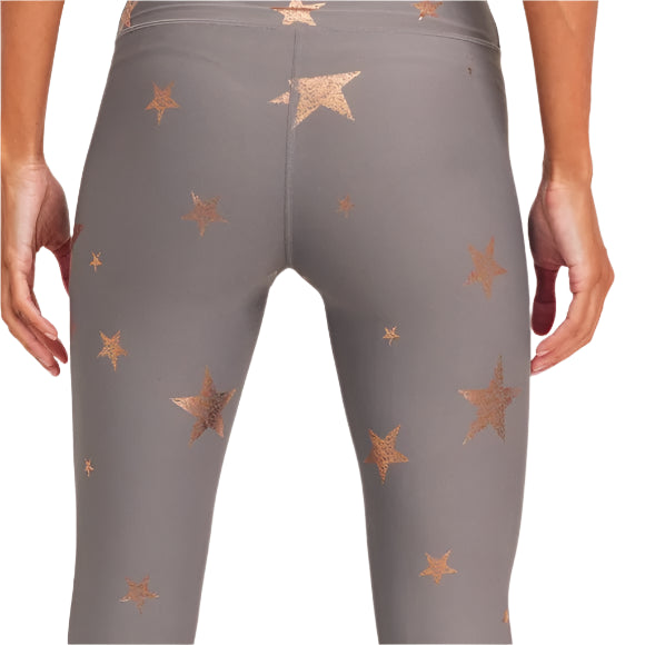 Gray leggings with star patterns on a neutral background